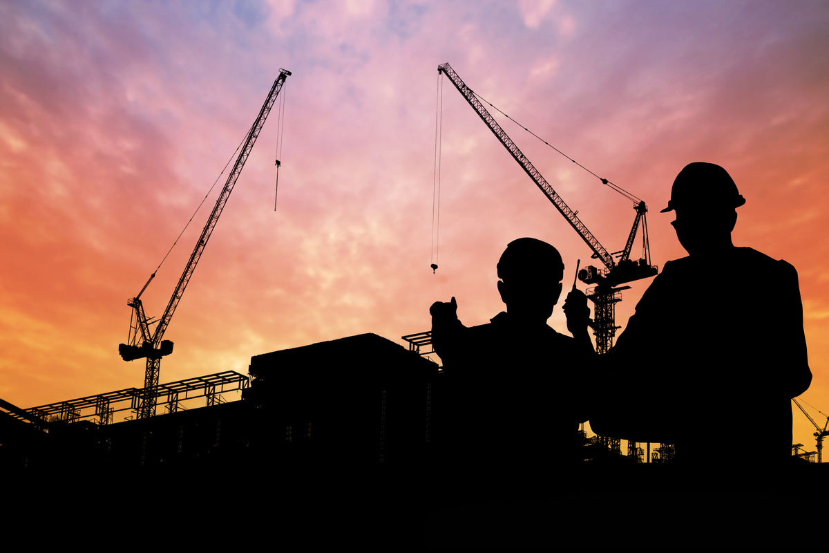 Silhouette of Engineers with Worker in Construction Building